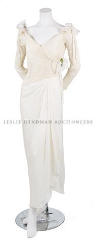 A Zandra Rhodes Silk Blend Dress, Size 8.: A Zandra Rhodes Silk Blend Dress, 1980s, with boned and fitted surplice pleated bodice, three-quarter sleeves, silk flower decorations, fully lined. Labeled: Zandra Rhodes London/Neiman Marcus. Size 8