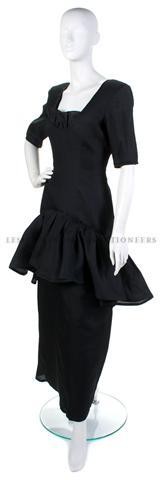 An Yves Saint Laurent Black Silk Gazar Evening Gow: An Yves Saint Laurent Black Silk Gazar Evening Gown, probably early 1990s, with a ruffle at neckline, flounce skirt. Labeled: Yves Saint Laurent. Size 40.