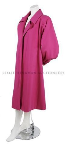 A Yves Saint Laurent Couture Magenta Wool Swing Co: A Yves Saint Laurent Couture Magenta Wool Swing Coat, 1980s, with a large notch collar, closureless, fully lined. Labeled: Yves Saint Laurent/59337.