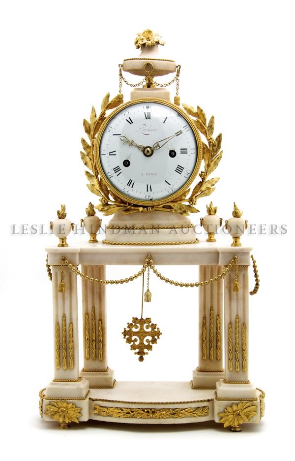 An Ormolu Mounted Alabaster Clock, Pochon a Paris,: An Ormolu Mounted Alabaster Clock, Pochon a Paris, the enameled dial with Roman numerals set within a laurel wreath above four columns having urn form finials and decorated with swags, raised on a con