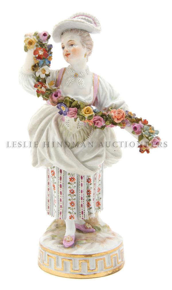 A Meissen Porcelain Figure, Height 6 1/2 inches.: A Meissen Porcelain Figure, 19th century, depicting a girl holding a floral garland, impressed 42, incised j67, having crossed swords mark in underglaze blue. Height 6 1/2 inches. Property from the Es