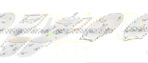 A Meissen Porcelain Tete-a-Tete, Height of tallest: A Meissen Porcelain Tete-a-Tete, comprising a teapot, two teacups with saucers and a creamer, each with floral decoration, having crossed swords mark in underglaze blue. Height of tallest 4 3/4 inches