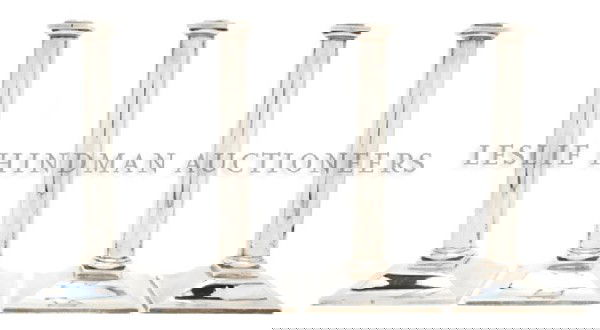 A Set of Four English Silver Candlesticks, John Sw: A Set of Four English Silver Candlesticks, John Swift, London, 1759, of columnar form, raised on a sloped square foot; approximate total weight 61.76 ozt. Height 10 3/8 inches.