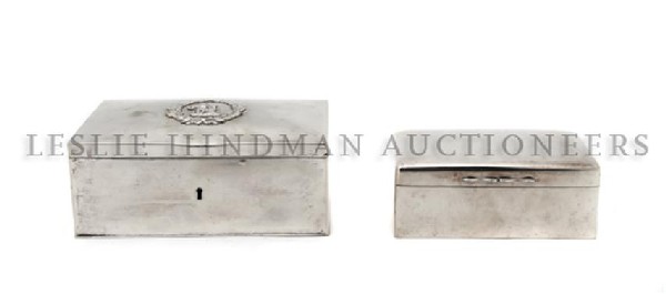 An English Silver Cigarette Box, Width of first 5 : An English Silver Cigarette Box, of rectangular form, with wood liner, together with a continental silver example. Width of first 5 1/2 inches. Property from the Estate of John and Valere Butterwick, 
