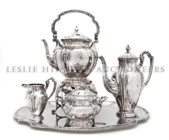 A Continental Silver Tea Service, Width of tray 9 : A Continental Silver Tea Service, comprising hot water kettle on stand and coffee with ivory insulators, sugar, creamer and a tray, each of lobed form with laurel branches and berries, marked 835M; ap