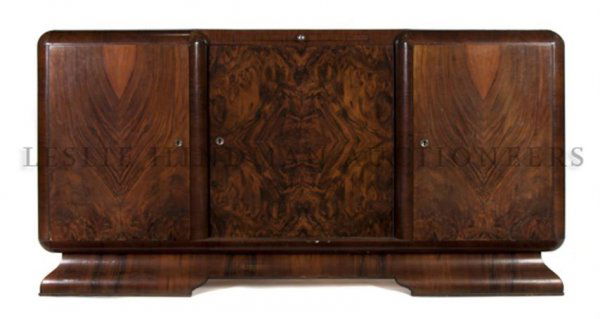 A French Art Deco Mahogany Server, Height 40 x wi: A French Art Deco Mahogany Server, of block front form, having a serving slide over three paneled doors raised on a plinth base. Height 40 x width 78 x depth 22 3/4 inches.