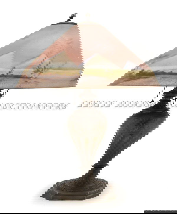 A Pairpoint Reverse Painted and Cast Metal Table: A Pairpoint Reverse Painted and Cast Metal Table Lamp, the reverse painted Garden of Allah shade raised on the urn form standard decorated with mythical beasts and epergnes of fruit above the stepped