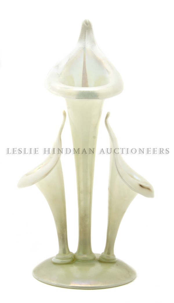 A Steuben Calcite Glass Epergne, Height 12 1/4 in: A Steuben Calcite Glass Epergne, having a central jack-in-the-pulpit vase flanked by two smaller examples raised on a circular base, original sticker taped to base. Height 12 1/4 inches. Property from