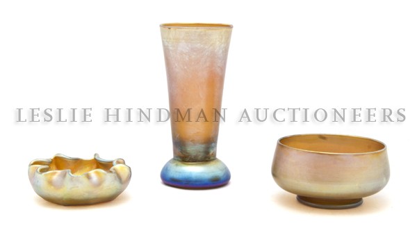 A Collection of Three Tiffany Favrile Glass Artic: A Collection of Three Tiffany Favrile Glass Articles, comprising a vase, bowl and salt with ruffled rim, the first two signed L.C.T. Favrile, the third signed L.C.T. Height of tallest 4 3/4 inches.