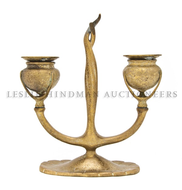 A Tiffany Studios Gilt Bronze Two-Light Candlesti: A Tiffany Studios Gilt Bronze Two-Light Candlestick, having two candle cups over oval base, signed Tiffany Studios and stamped 1230 New York with Tiffany Studios logo. Height 8 1/4 inches.