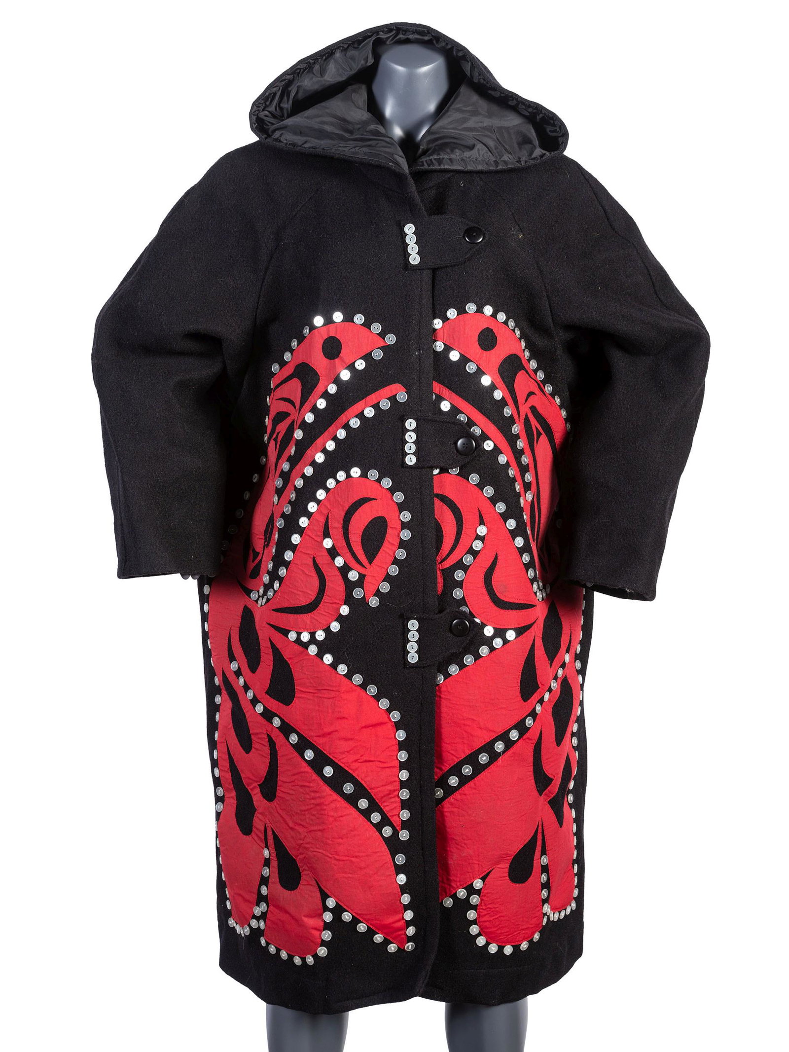 Contemporary Haida Button Coat: Contemporary Haida Button Coat circa 2000 coat designed with avian imagery and embellished with pearl colored buttons on front; frog imagery on verso length 42 inches x chest 56 inches Please Note: Th