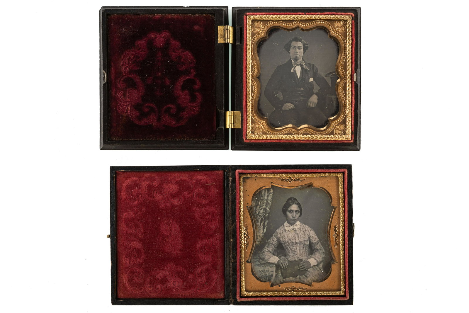 [EARLY PHOTOGRAPHY - PORTRAITURE]. A pair of: [EARLY PHOTOGRAPHY - PORTRAITURE]. A pair of daguerreotype portraits of mixed race subjects. Sixth plate daguerreotype portrait of a mixed race woman wearing a patterned dress and holding a book in he