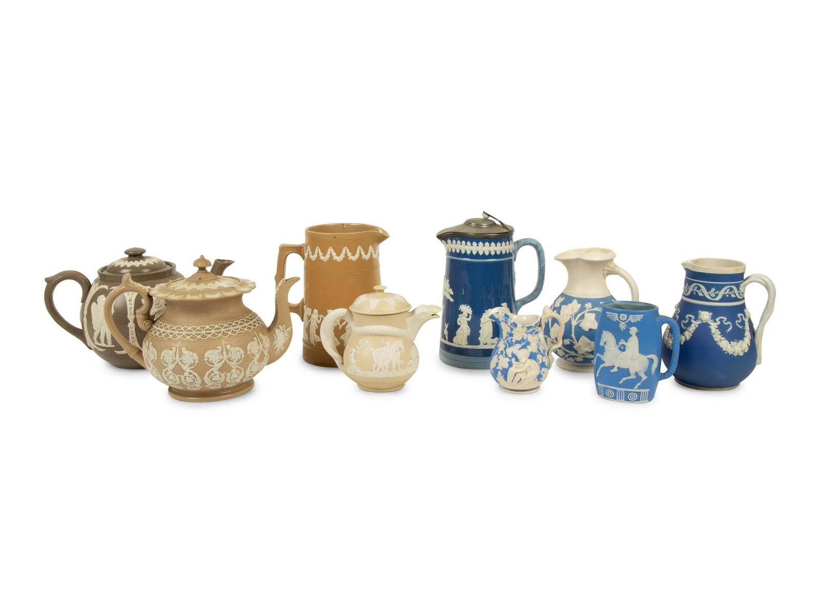 A Collection of Nine English Salt Glazed Relief Form: A Collection of Nine English Salt Glazed Relief Form Teapots, Pitchers and Creamers 19TH/20TH CENTURY by various makers including Copeland, Rockingham, and Samuel Alcock. Height of tallest 7 inches.