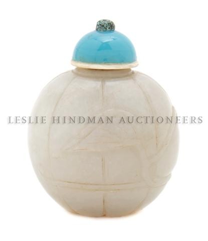 A Melon Form Jade Snuff Bottle, Height of bottle 1 3: A Melon Form Jade Snuff Bottle, of mutton fat colored stone of compressed globular form carved with the lobes of the melon with carved tentacles and leaves, with later glass and turquoise stopper. Hei
