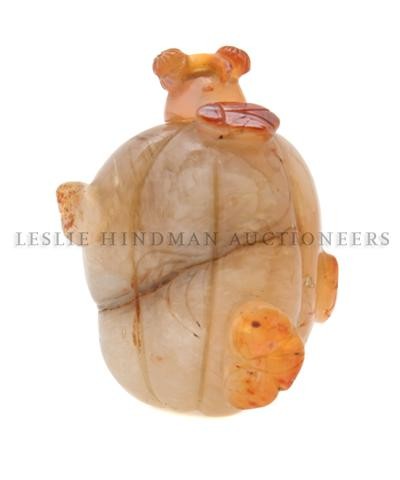 A Melon Form Carnelian Snuff Bottle, Length of bott: A Melon Form Carnelian Snuff Bottle, of typical ribbed form with raised beetles throughout, with carved agate stopper. Length of bottle 2 inches. Property of a Private Midwest Collector