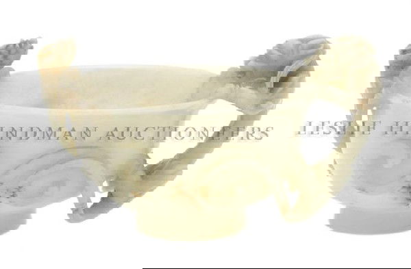 A White Jade Libation Cup, Diameter 4 inches.: A White Jade Libation Cup, having high relief carving of kylin on the rims with an area of russet on one's tail, raised upon a circular foot. Diameter 4 inches.