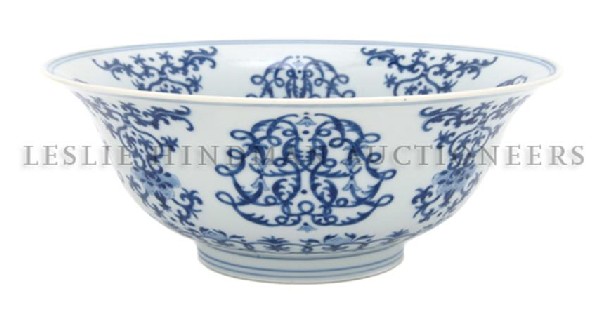 A Chinese Porcelain Bowl, Diameter 8 3/4 inches.: A Chinese Porcelain Bowl, 18th century, having underglaze blue decoration of panels of interlaced foliage, the center roundel depicting a swastika at the center surrounded by waves and other buddhist 