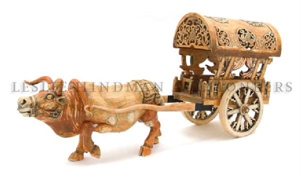 A Chinese Carved Ivory Ox and Cart, Length 20 inch: A Chinese Carved Ivory Ox and Cart, the near amber colored ivory carved to show an ox with yoke in a striding pose, the cart having pierce carved roundels and foliate decoration with curtains and rais