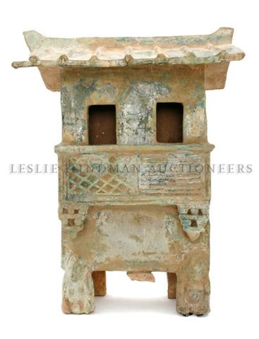 A Chinese Pottery Green Glazed Building, Height 21: A Chinese Pottery Green Glazed Building, Han Dynasty, having iridescent green glaze throughout with tiled roof above the two story structure, raised on stilt legs having figures at front. Height 21 1/