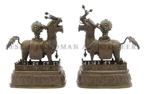 A Pair of Southeast Asian Bronze Beasts, Height ov: A Pair of Southeast Asian Bronze Beasts, each animal with spiraling tendrils issuing below the nostrils and open mouth, having inset hardstone bosses throughout and raised on a galleried rectangular b