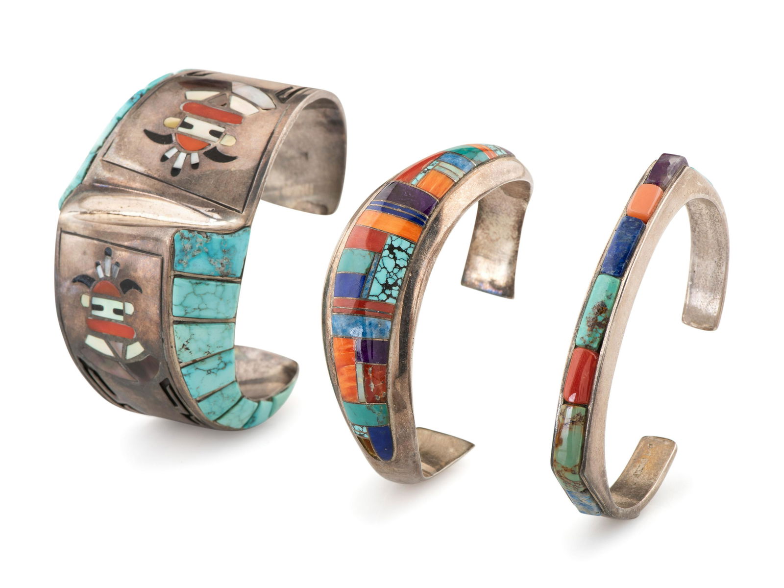 Navajo and Jemez Silver and Mosaic Inlay Cuff Bracelets: Navajo and Jemez Silver and Mosaic Inlay Cuff Bracelets third quarter 20th century lot of 3, includes: a tapered cuff, set with colorful mosaic inlay; marked STERLING DINE and signed by Frank Chee (Di