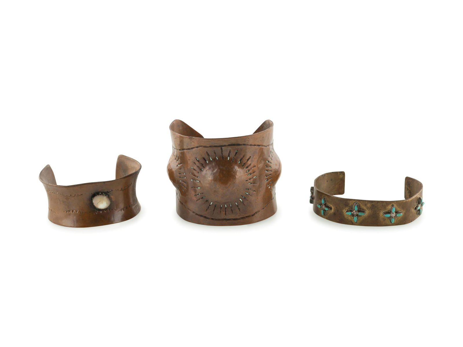 Navajo Copper and Brass Cuff Bracelets: Navajo Copper and Brass Cuff Bracelets mid - third quarter 20th century lot of 3, include: a wide copper cuff with chiseled designs radiating from three graduated circular repousse designs; not marked