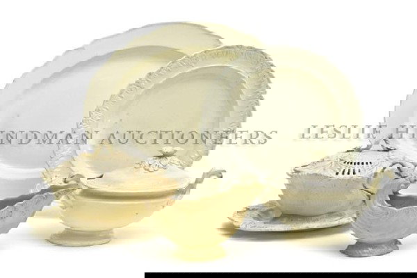 A Collection of Five Ceramic Creamware Table Vessel: A Collection of Five Ceramic Creamware Table Vessels, the first a quatrefoil tureen having conforming under plate, the second a sauce boat of shell form, the third a tureen of oval form, the fourth a