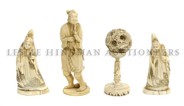 A Group of Three Asian Carved Ivory Figures: A Group of Three Asian Carved Ivory Figures, a Japanese figure of a man smoking a pipe, two figures depicting Chinese deities, and a puzzle ball. Height of first 6 inches.