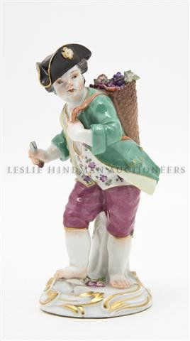 A Meissen Porcelain Figurine, Height 5 1/8 inches: A Meissen Porcelain Figurine, depicting a young grape harvester, impressed 1470, incised 8, having crossed swords mark in underglaze blue. Height 5 1/8 inches.