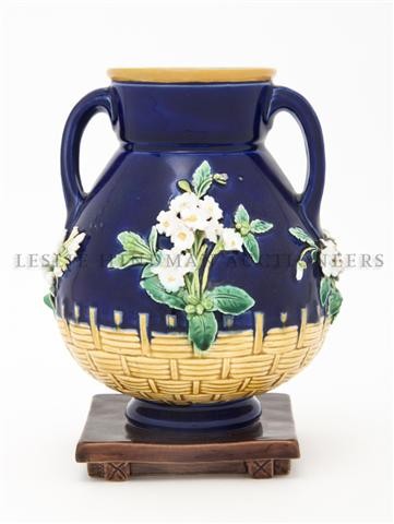 A Minton Majolica Vase, Height 6 3/4 inches.: A Minton Majolica Vase, of double handled form, with cobalt reserve and floral decoration, the lower half with faux basket weave decoration on a square foot. Height 6 3/4 inches. Property of a Lady, O