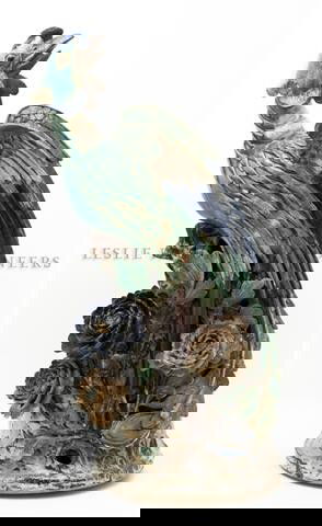 A Terracotta Phoenix, Height 31 1/2 inches.: A Terracotta Phoenix, the bird depicted with slightly opened wings, having polychrome glaze throughout and raised upon a naturalistically formed base. Height 31 1/2 inches.