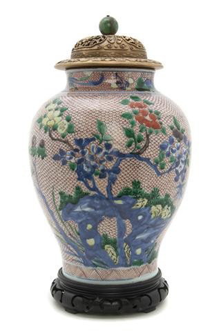 A Chinese Baluster Vase, Height of vase 12 inches.: A Chinese Baluster Vase, having underglazed blue decoration with enameled floral scenes with a repetitive iron red scale pattern in the reserve, having pierce carved wood lid with hat finial jade bead