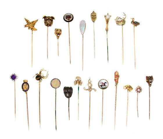A Group of Yellow Gold Stick Pins, 42.45 dwts.: A Group of Yellow Gold Stick Pins, consisting of 21 pins including a bird's claw clutching a pearl, an enameled Order of the Garter pin, a bear's head with ruby eyes clutching an old mine cut diamond 