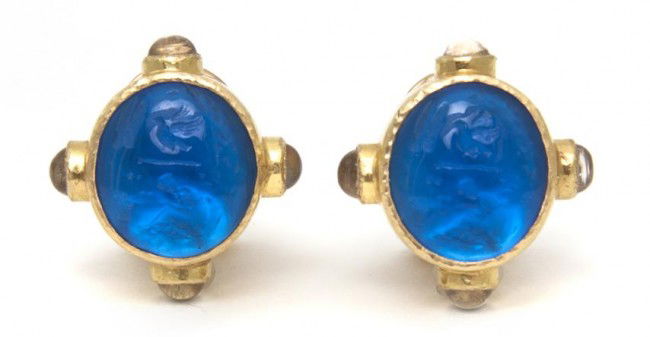 A Pair of 18 Karat Yellow Gold, Moonstone and Blue: A Pair of 18 Karat Yellow Gold, Moonstone and Blue Glass Earclips, Elizabeth Locke, containing two oval cabochon cut and carved blue glass set with mother-of-pearl backing within a hammered gold colle