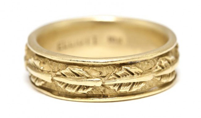 An 18 Karat Yellow Gold Band, 6.10 dwts.: An 18 Karat Yellow Gold Band, with a repeating leaf design. Stamp: ELLIOT 18K. Size 7 3/4. 6.10 dwts. Property of a Lady, Palm Beach, Florida