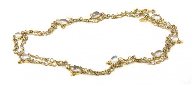 An 18 Karat Yellow Gold, Moonstone and White Sapph: An 18 Karat Yellow Gold, Moonstone and White Sapphire Necklace, containing nine oval cabochon cut moonstones measuring approximately 8.00 x 6.00 mm and 82 round brilliant cut white sapphires weighing