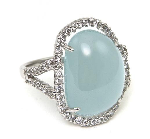 An 18 Karat White Gold, Blue Chalcedony and Diamon: An 18 Karat White Gold, Blue Chalcedony and Diamond Ring, containing one free form cabochon cut blue chalcedony measuring approximately 17.00 x 12.60 mm and 69 round brilliant cut diamonds weighing ap