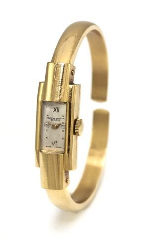 An 18 Karat Yellow Gold Bangle Watch, Baume & Merc: An 18 Karat Yellow Gold Bangle Watch, Baume & Mercier, 11.50 mm case diameter, matte silvered dial, Roman and dot numerals, gilt baton hands, snap on case back, 17 jewel manual wind movement signed B 