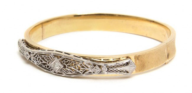 A 14 Karat Yellow Gold, Platinum and Diamond Bangl: A 14 Karat Yellow Gold, Platinum and Diamond Bangle Bracelet, containing three old European cut diamonds weighing approximately 0.09 carat total. Stamp: RINE 14K. 9.60 dwts. Property from the Estate o