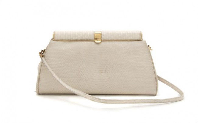 A Judith Leiber Cream Lizardskin Clutch, 7 1/2 x 4: A Judith Leiber Cream Lizardskin Clutch, with interchangeable goldtone and lizardskin shoulder strap. Stamped: Judith Leiber. 7 1/2 x 4 inches. Property from the Collection of Beverly B. Bernstein, Wa