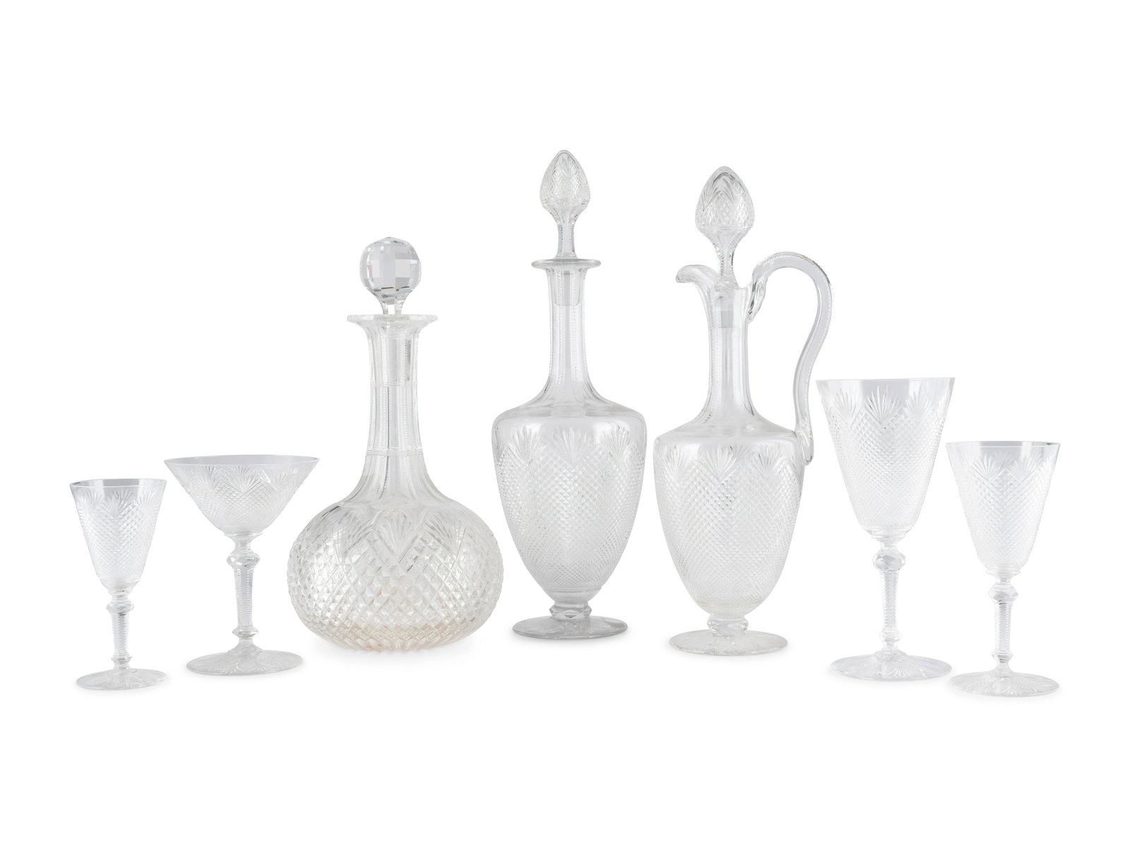A Collection of Diamond Cut Glass Stemware: A Collection of Diamond Cut Glass Stemware 20th Century comprising four decanters, seventeen champagnes, six wine glasses, seventeen claret glasses, and ten cordials. 54 items total. Height of largest