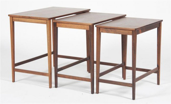 A Set of Three Stacking Teak Tables, Height of lar: A Set of Three Stacking Teak Tables, each having a rectangular top and tapering square legs joined by stretchers. Height of largest table 19 x width 21 3/4 x depth 13 5/8 inches. Property from the Est
