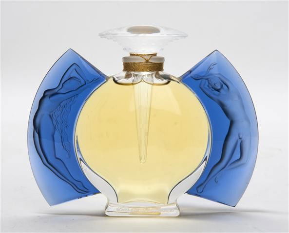 A Lalique Molded and Frosted Glass Perfume Bottle,: A Lalique Molded and Frosted Glass Perfume Bottle, the circular bottle flanked by two nudes in blue glass. Height 3 3/4 inches.