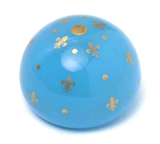 A Baccarat Opaline Glass Paperweight, Diameter 2 1: A Baccarat Opaline Glass Paperweight, with gilt fleur de lis decoration. Diameter 2 1/2 inches. Property from the Estate of Norma Stone, Chicago, Illinois