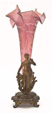 An Iridescent Glass and Gilt Metal Figural Epergne: An Iridescent Glass and Gilt Metal Figural Epergne, depicting a woman with a basket of flowers raised on a stepped base with scrolling toes, the glass of tapering form with ruffled rim. Height 14 1/2 
