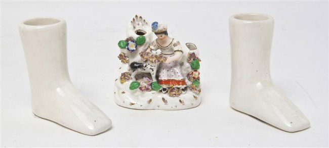 A Staffordshire Figural Candleholder, Height of fi: A Staffordshire Figural Candleholder, depicting a shepherdess and sheep, together with two Wedgwood ceramic boots. Height of first 3 5/8 inches. Property from the Estate of Naomi T. Borwell, Chicago, 