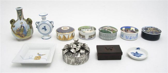 A Collection of Seven Decorative Boxes, Height of: A Collection of Seven Decorative Boxes, comprising five porcelain, a silverplate and a bronze example, together with two vases and two trays. Height of tallest 7 inches. Property from the Estate of Na