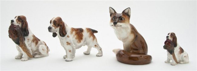 A Group of Three English Porcelain Dogs, Height of: A Group of Three English Porcelain Dogs, comprising two examples by Royal Doulton of a hunting dog with a pheasant, numbered HN 1029 and 1028, together with a bone china example by Paragon of a simila