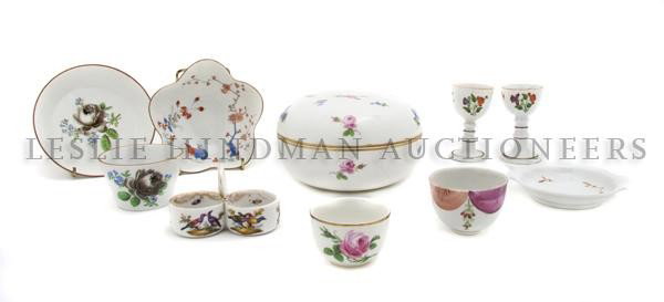A Group of Meissen Porcelain Table Articles, Diame: A Group of Meissen Porcelain Table Articles, comprising a circular covered box, a floriform dish, a cup and saucer, two additional cups and a saucer, a salt and two egg cups. Diameter of first 6 inche