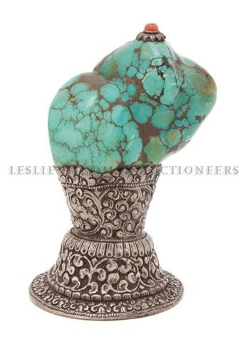 A Southeast Asian Turquoise Seal, Height 4 1/4 inc: A Southeast Asian Turquoise Seal, having silver metal mounts under the natural pebble form turquoise. Height 4 1/4 inches.